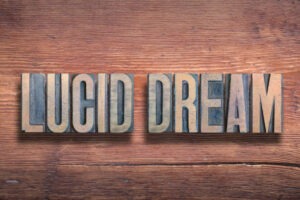 The words 'Lucid Dream' arranged on a wooden table, symbolizing awareness and dream contro