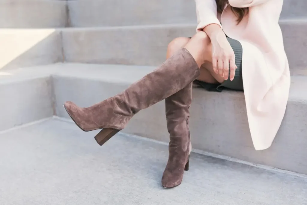 Two women’s legs wearing stylish brown boots, symbolizing the journey ahead in life.