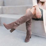 Two women’s legs wearing stylish brown boots, symbolizing the journey ahead in life.